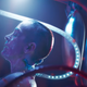An unconscious, slime-covered Neo is raised from his Matrix pod with a tube still attached to his neck.